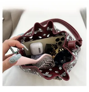 Internal view of burgundy bucket bag showing large capacity with daily essentials