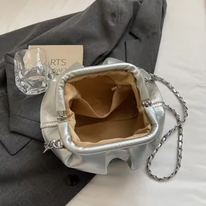 Chic silver pleated bucket bag with metallic finish and metal chain shoulder strap
