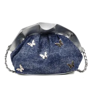 Minimalist blue denim bucket bag for women with silver butterfly accents and chain strap