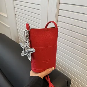 Chic red lychee leather small bucket bag for phone with silver star pendant detail