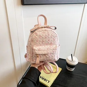 Pink floral embossed backpack for women with golden hardware and cute bow detail