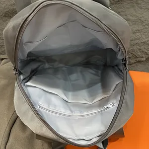 Waterproof grey nylon backpack with multi-compartment interior and wet-dry separation