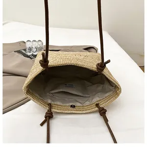 Macro shot of straw tote bag interior featuring fabric lining and zipper pocket detail