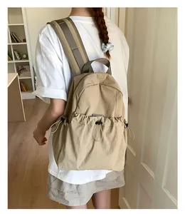 Detailed back view of khaki nylon backpack with unique drawstring pocket for students