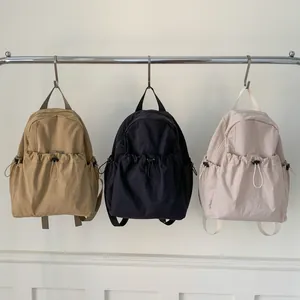 Minimalist school backpack with drawstring pockets in khaki, black, and beige colors