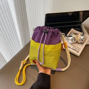 Fashionable bucket bag in purple and yellow with thick rope strap and drawstring