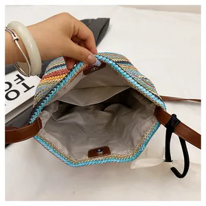 Detail showing internal lining and magnetic snap closure of a colorful straw bucket bag