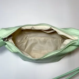 Top view of mint green shoulder bag showing interior lining and zipper pocket