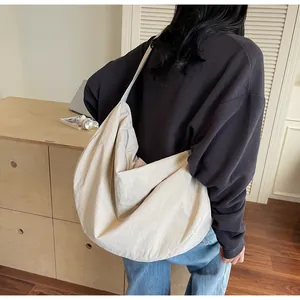 Detailed view of cream-colored oversized hobo bag showing natural pleated texture and shape