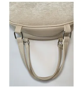 Top view of two-tone beige handbag featuring velvet and PU leather stitch detailing
