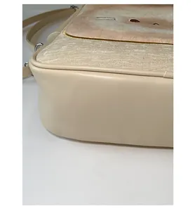 Detailed view of the beige patchwork handbag showing precision stitching and PU leather