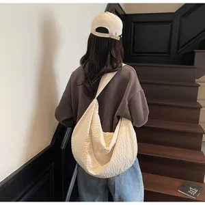Detailed back view of a cream woven hobo bag with textured fabric for daily commuting