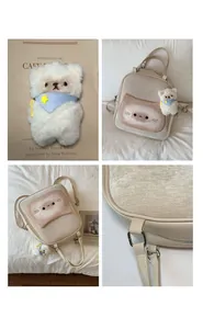 Detail view of beige backpack featuring cartoon cat print and plush bear accessory