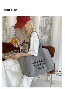 Close-up of a striped canvas tote bag with 'Make Magic HAPPEN 1995' print on it