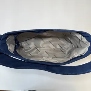 Large capacity navy canvas tote bag featuring interior lining with logo and zipper pocket