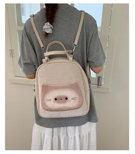 Detail view of beige toast-shaped backpack with cute cat illustration on model's back