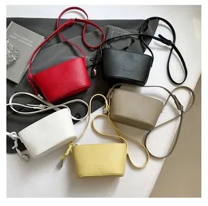 Flat lay of mini bucket bags in five colors with lychee texture and fashion lettering