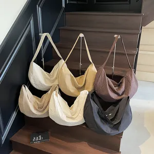 Minimalist large capacity woven tote bags in multiple colors shown on stairs
