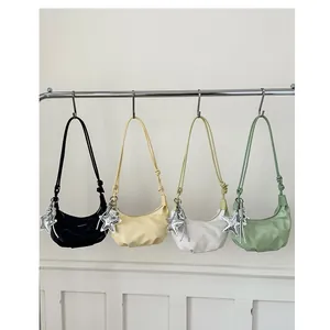 Chic croissant underarm bags in four colors with star pendants and sleek shoulder straps