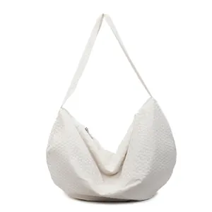 Minimalist white quilted shoulder bag with woven texture and half-moon tote design