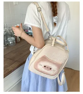 Detail of a chic beige backpack with a cute cat illustration and adjustable straps