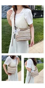 Detail view of rainbow striped straw shoulder bag with decorative floral bag charm