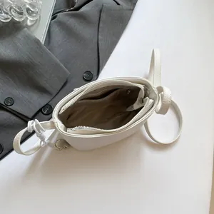 White lychee pattern bucket bag with interior zip pockets and heart charm