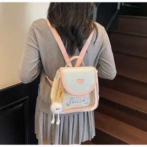 Detail of sweet ita bag with pink heart cutout and transparent window on cream leather