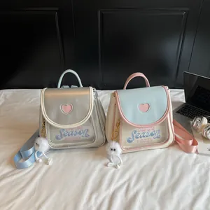 Japanese style cute mini ita backpack with heart cutout and plush ball pendant in pastel colors