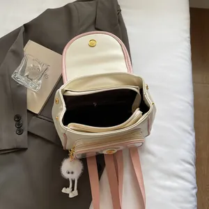 Off-white and pink dopamine style backpack with multiple layers and plush doll charm