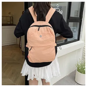 Detail eines pfirsichfarbenen Rucksacks mit robustem Nylonstoff und Reißverschlüssen