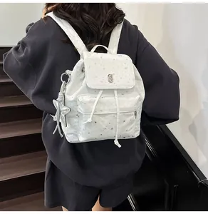 Close-up of a white Korean style star pattern backpack with drawstring and silver star charm