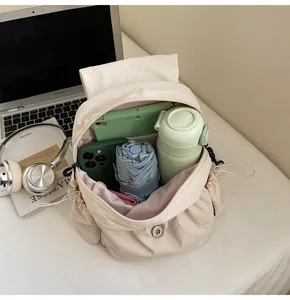 Interior view showing the large storage capacity of this off-white canvas backpack
