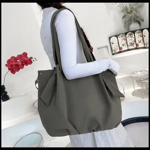 Detail of olive green canvas tote bag with side knot accents and large capacity