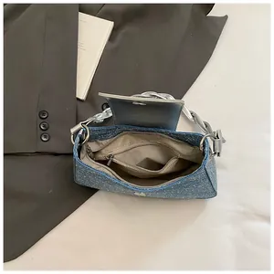 Blue sequined denim shoulder bag with magnetic closure and silver woven handle