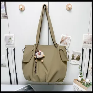 Macro view of canvas tote bag showing side bow tie detail and cute lamb plush charm