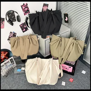 Close-up of stylish large canvas tote bags with bow knot details in four trendy colors