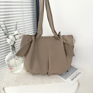 Large khaki canvas tote bag with ribbon knots for women, stylish minimalist shoulder bag
