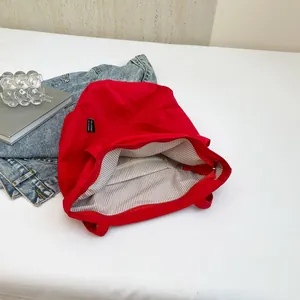 Red canvas tote bag with 'YES HONEY' patch and striped lining for daily use