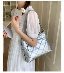 Close-up of silver quilted shoulder bag with diamond accents and fashion tag detail