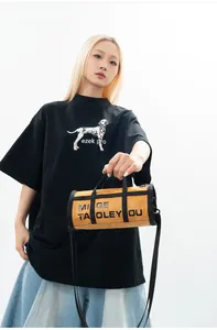 Detailed view of stylish yellow barrel bag in DuPont paper texture with crossbody strap