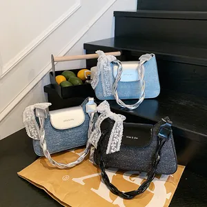 Three trendy denim and glitter shoulder bags with rope handles and lace bow detail