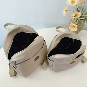 Waterproof beige nylon backpack set in two sizes for students and travel use