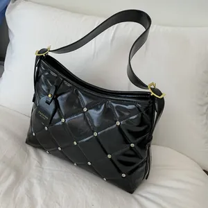 Black quilted shoulder bag with silver studs and a glossy finish for fashion women