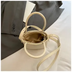 Top view showing the spacious interior compartments and zip pockets of the beige handbag