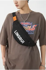 Detail of waterproof black oxford fabric chest bag with white logo and orange accent tag