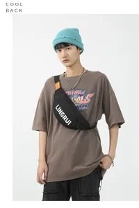 Close-up of black waterproof oxford chest bag with white LINGRUI lettering and orange accents