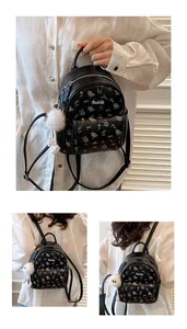 Detail of floral mini backpack with plush pom-pom and Keddy metal brand label