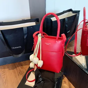 Elegant red faux leather mini tote bag with tulip charm and adjustable crossbody strap