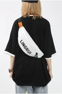 Detail of white waterproof oxford chest bag with black strap and orange label